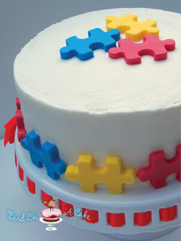 Autism Puzzle Piece Cake logo