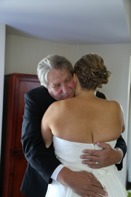Father and bride hug